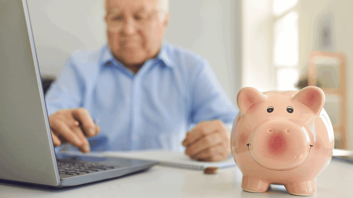 A sir with a pig-bank illustrating the negative impact of investment fees or longevity risk, common Retirement Planning Mistakes, on a retirement portfolio.